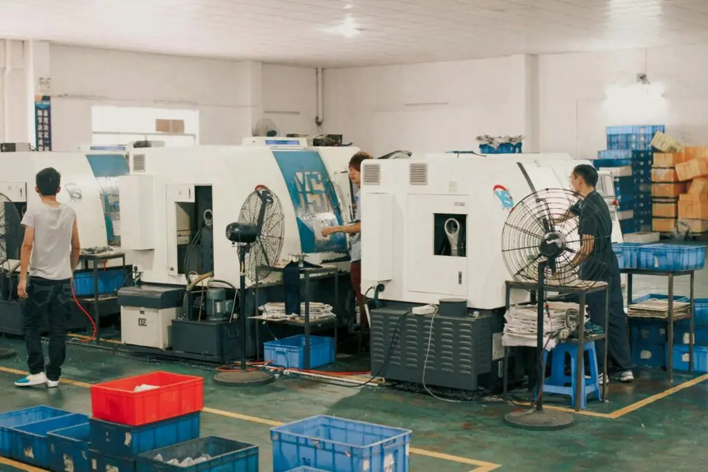 aerospace Workers operating machinery in an industrial factory setting, showcasing manual labor and production.